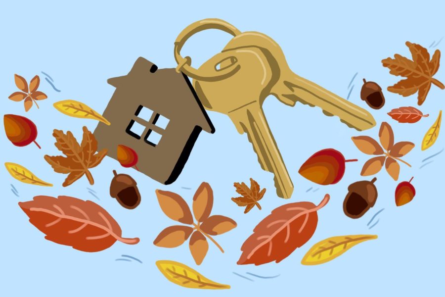 A house keychain with an attached set of keys, surrounded by leaves and a light blue background.