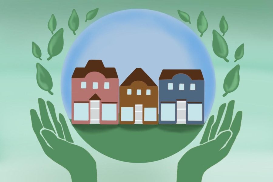 A pair of hands forms a circle around a small picture of a row of houses. Green leaves and a green background surround the picture.