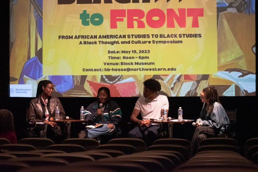 Four+people+sit+at+a+panel+in+front+of+rows+of+empty+chairs.+A+yellow+screen+in+the+back+reads+%E2%80%9CBlack+to+Front%3A+From+African+American+Studies+to+Black+Studies%3A+A+Black+Thought+and+Culture+Symposium.%E2%80%9D