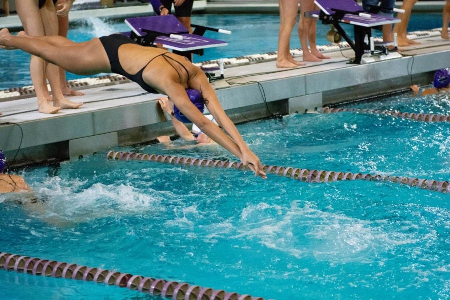 A swimmer dives into the water