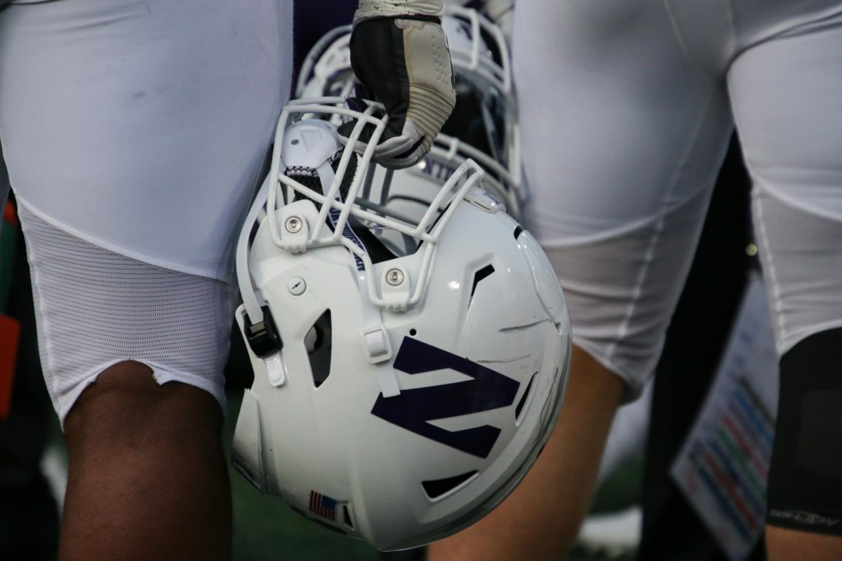 A Northwestern player holds a helmet. Interim head coach David Braun and three players spoke to the media Wednesday following NU’s first open practice of fall camp.