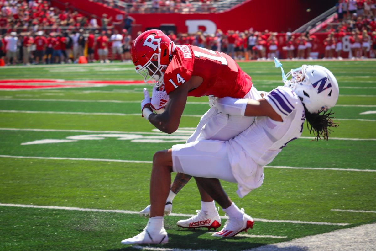 Senior defensive back Garnett Hollis Jr. attempts to wrap up Rutgers receiver Isaiah Washington on the sideline. Hollis tallied three tackles against the Scarlet Knights on Sunday.