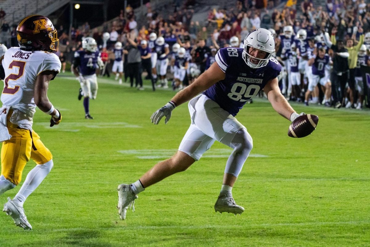 Senior tight end Charlie Mangieri runs across the end zone to give Northwestern the winning touchdown in overtime. The Wildcats defeated Minnesota 37-34 in a thrilling overtime comeback
