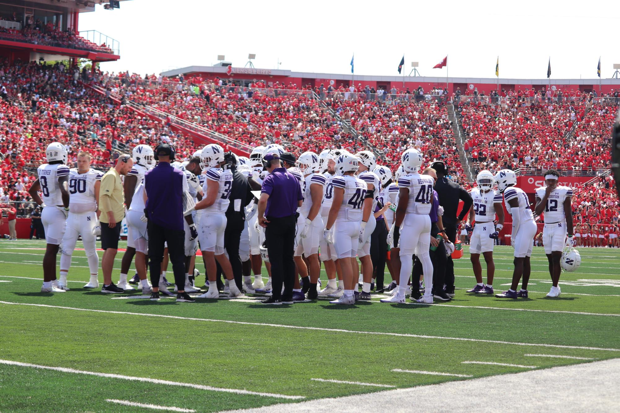 Northwestern’s team huddles together during a pause against Rutgers. The Wildcats host Minnesota under the lights at Ryan Field on Saturday night in NU’s Big Ten home opener.