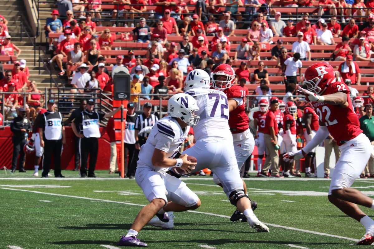 Graduate+student+quarterback+Ben+Bryant+looks+to+evade+the+rush+at+Rutgers.+Bryant+threw+for+116+yards+on+11+completions+against+UTEP+last+weekend.