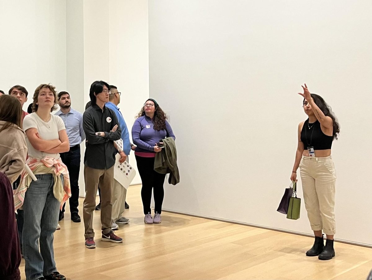 Northwestern community members gather around the tour guide as she describes Felix Gonzalez-Torres’ “Untitled” at Thursday’s Northwestern Night at the Art Institute.