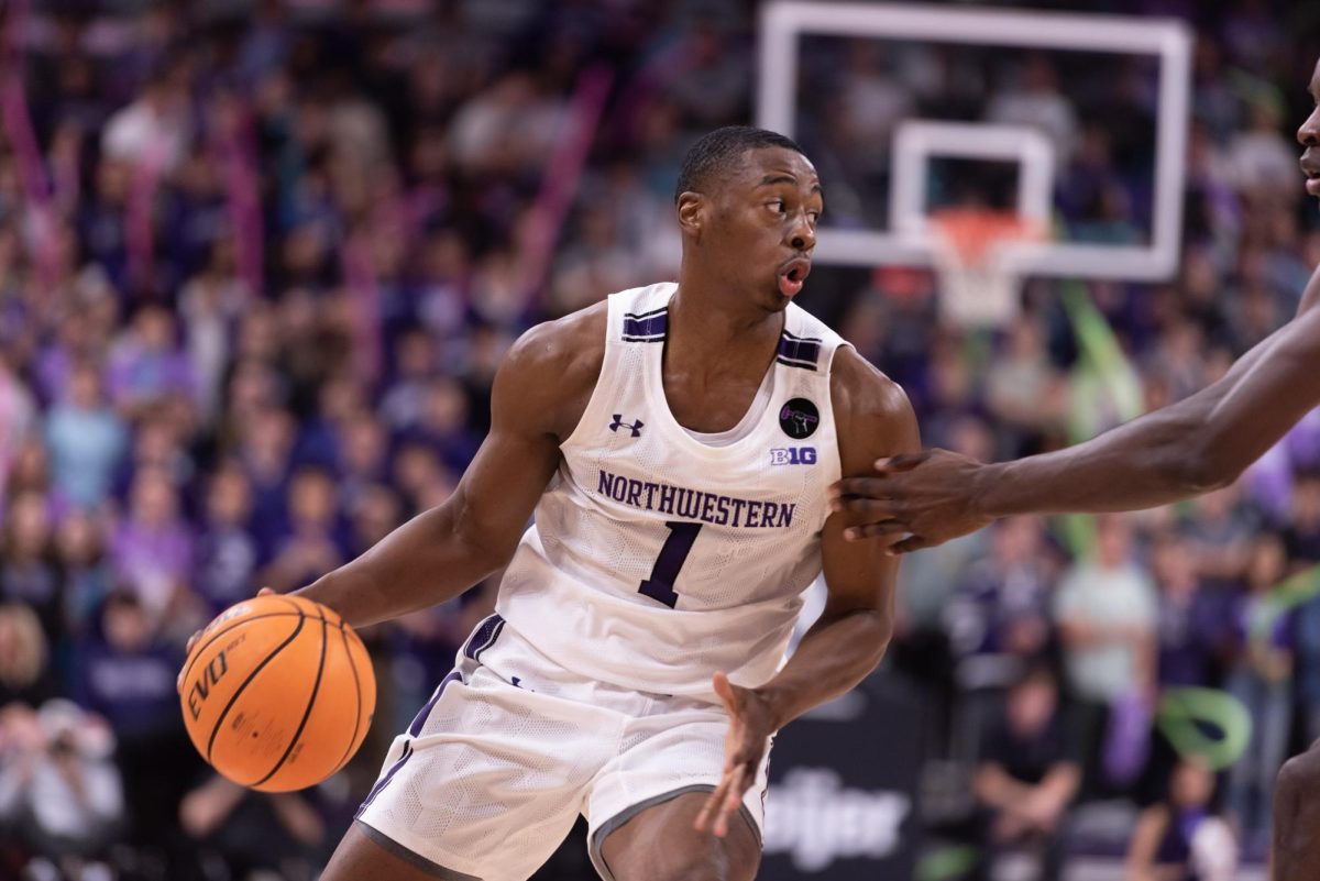 Former Northwestern guard Chase Audige dribbles the ball. After playing for the Miami Heat in the 2023 Summer League, Audige signed an Exhibit 10 contract with the Washington Wizards. 