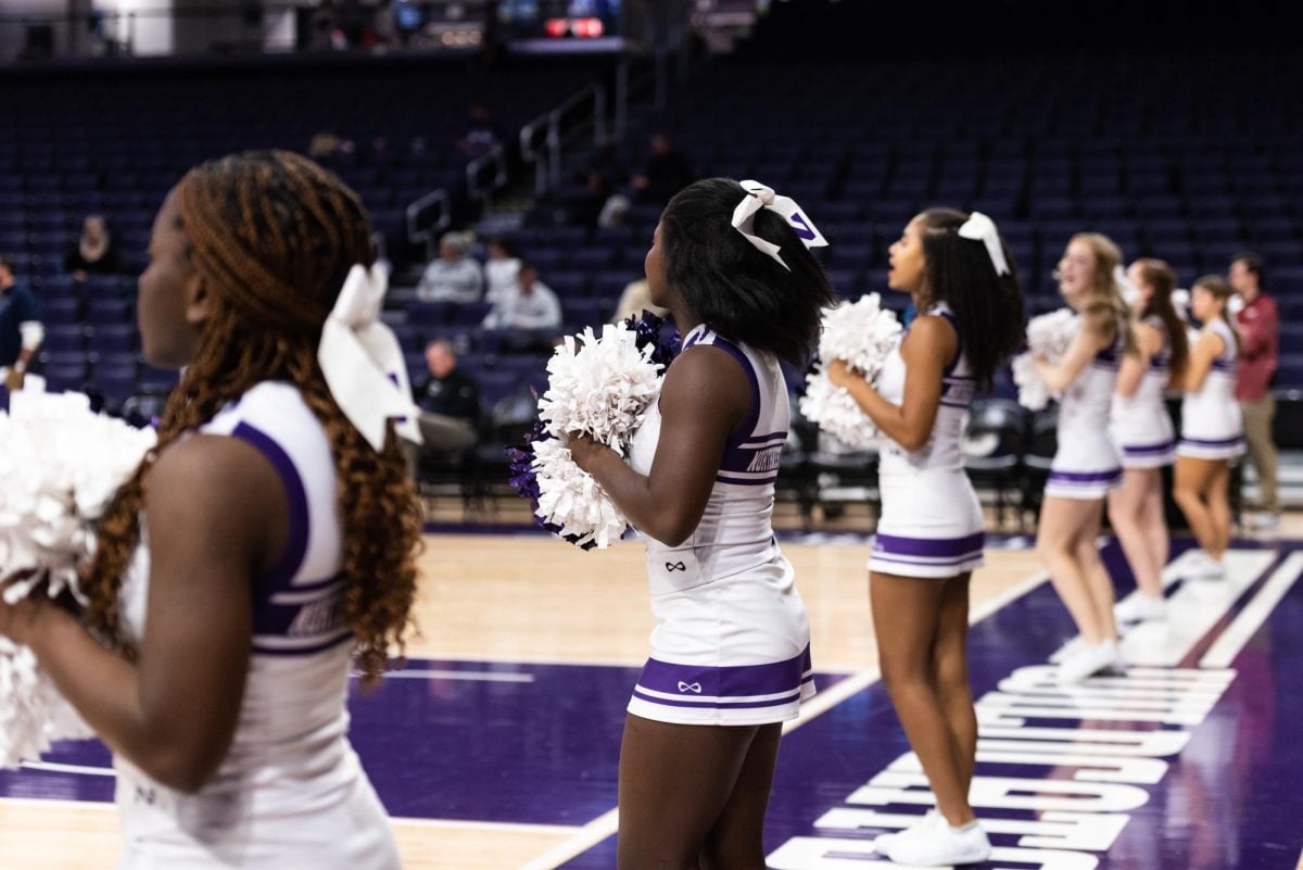 Northwestern cheer performs at a women’s basketball game against Penn in November 2022. Cheerleaders alleged safety concerns, a culture of body shaming and a lack of support from the athletic department to The Daily. 