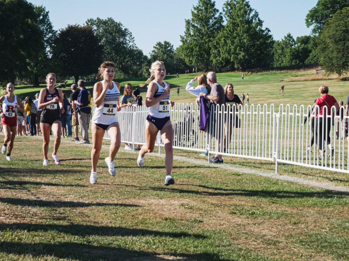 Juniors Ava Earl and Anna Hightower run in a race. Earl finished in the top-70 at the Virginia Invitational over the weekend. 