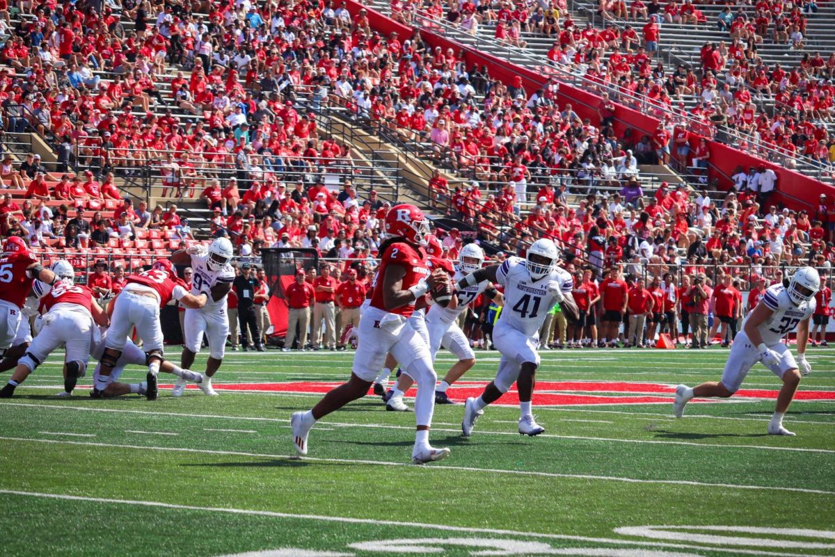 Rutgers quarterback Gavin Wimsatt rolls to his right while being pressured by graduate defensive lineman Jaylen Pate. NU finished with zero sacks on Sunday.