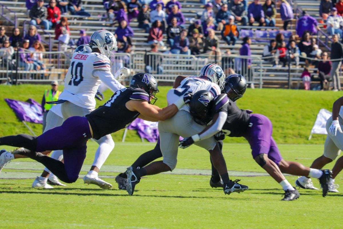 Multiple Northwestern defenders tackle Howard running back Eden James. In NU’s victory, the defense struggled to stop the Bisons run game, which led to a much closer game than expected.