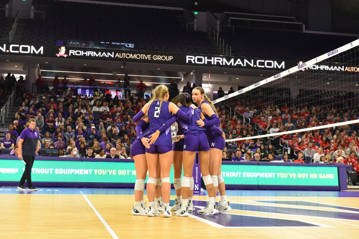 Northwestern players huddle together. The Wildcats were swept by Ohio State Wednesday.