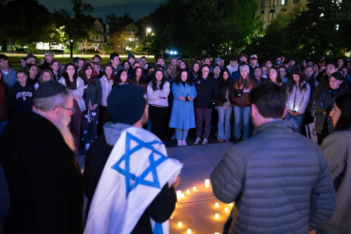 Close to 200 Northwestern community members gathered by candlelight outside Deering Library to honor the lives lost in the Israel-Hamas war.