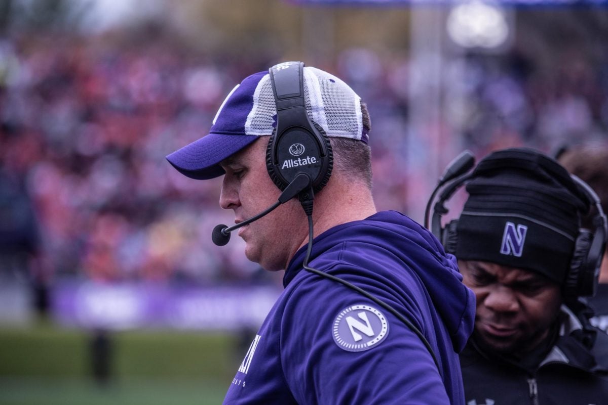 Former Northwestern head coach Pat Fitzgerald looks down during a game last year. Fitzgerald filed a $130 million lawsuit against the University and President Schill on Thursday.