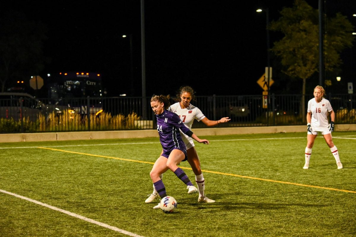 Senior forward Ella Hase holds off a Wisconsin defender. Hase tallied her seventh goal of the season and Northwestern’s lone score in the team’s 2-1 defeat to the Badgers on Thursday.