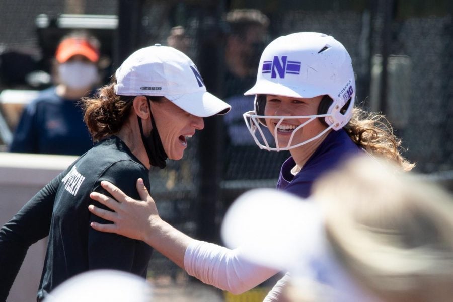 Coach Kate Drohan, who is entering her 23rd year at the helm of Northwestern, embraces a former player, Morgan Newport, in 2021. 
