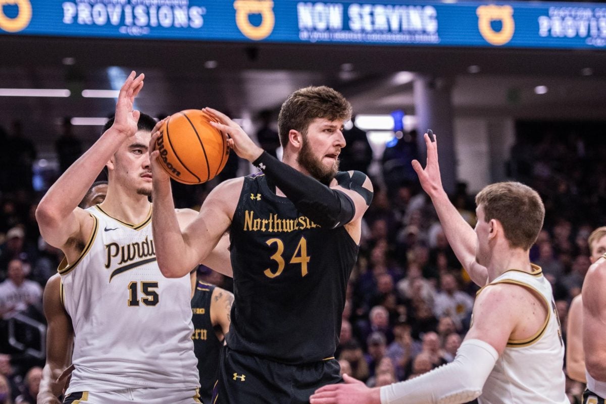 Matthew Nicholson looks to pass the ball in a victory over Purdue last season. Looking ahead to the 2023-24 season, Nicholson spoke of his high expectations both personally and for Northwestern.  