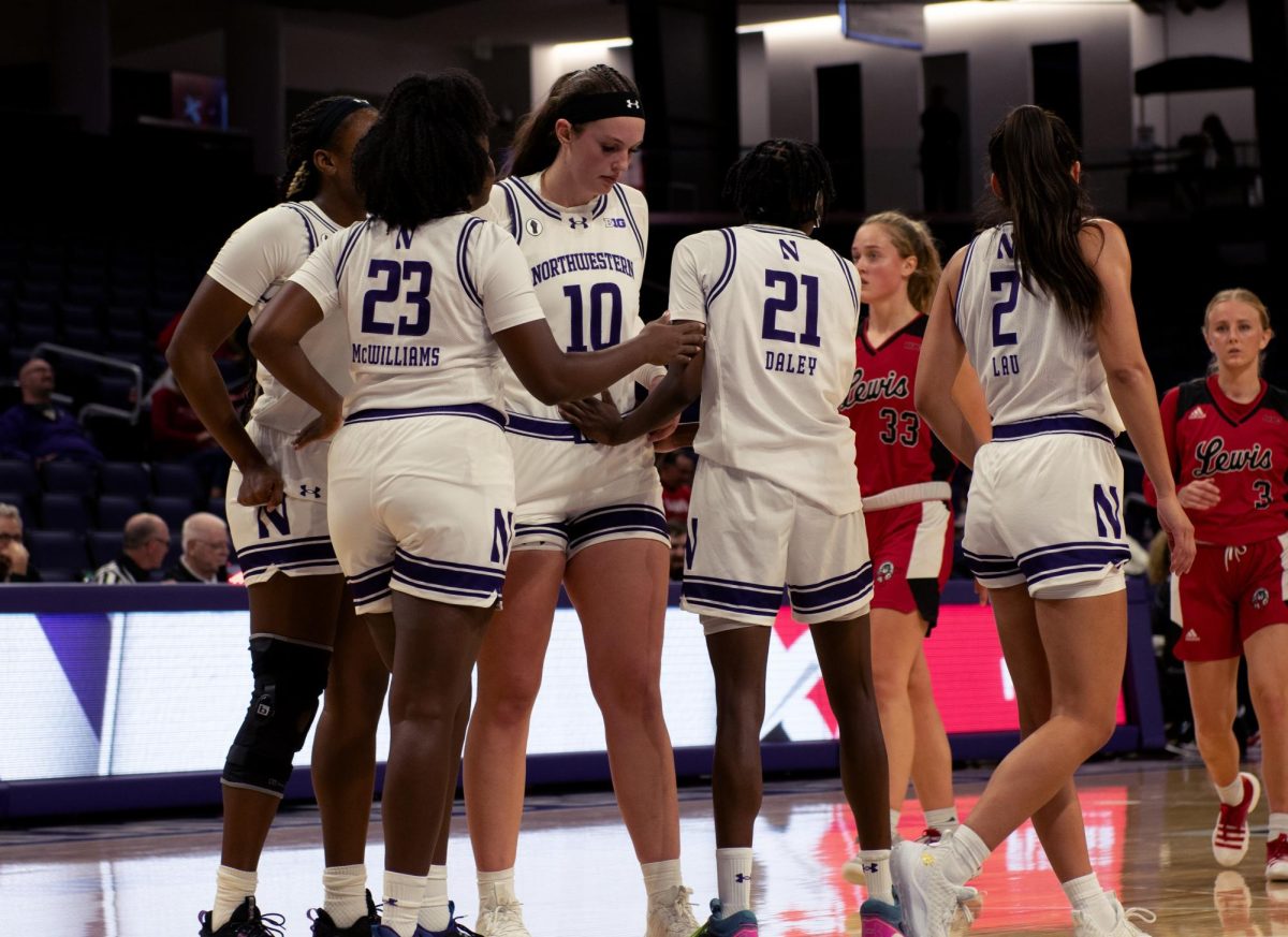 Northwestern players gather during an exhibition game against Lewis. The ‘Cats won all three of their games in Spain this past August.