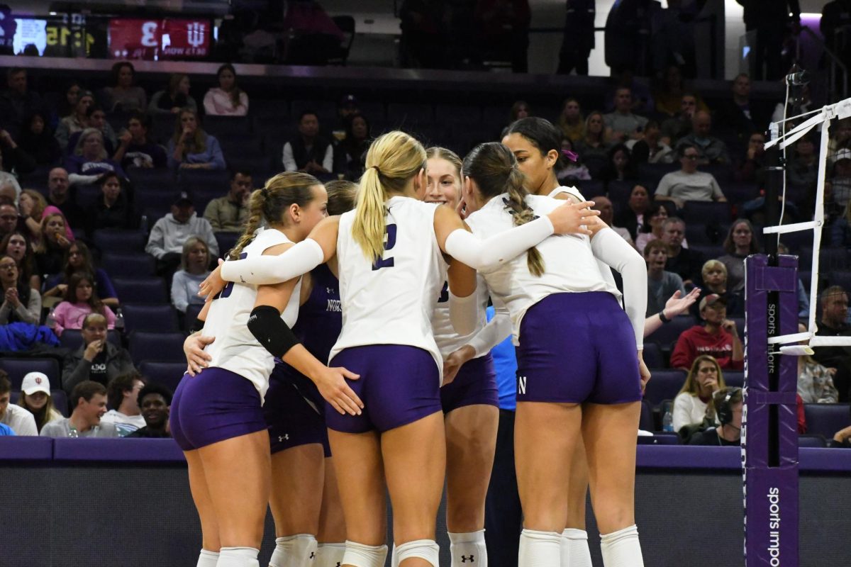 Northwestern huddles together. The Wildcats fell in three sets to in-state rival Illinois Wednesday.