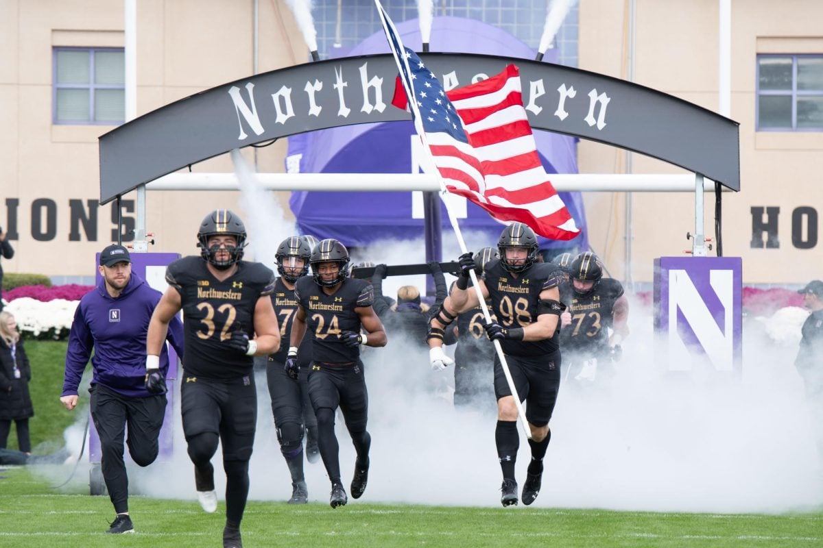 Northwestern runs out of the tunnel ahead of a game. 