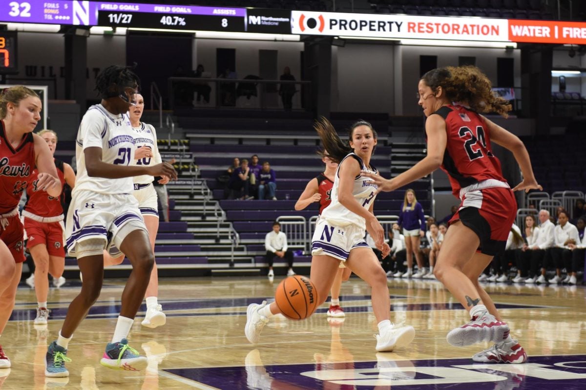 Sophomore guard Caroline Lau throws a bounce pass to junior guard Melannie Daley in Northwestern’s 80-54 exhibition win over Lewis.
