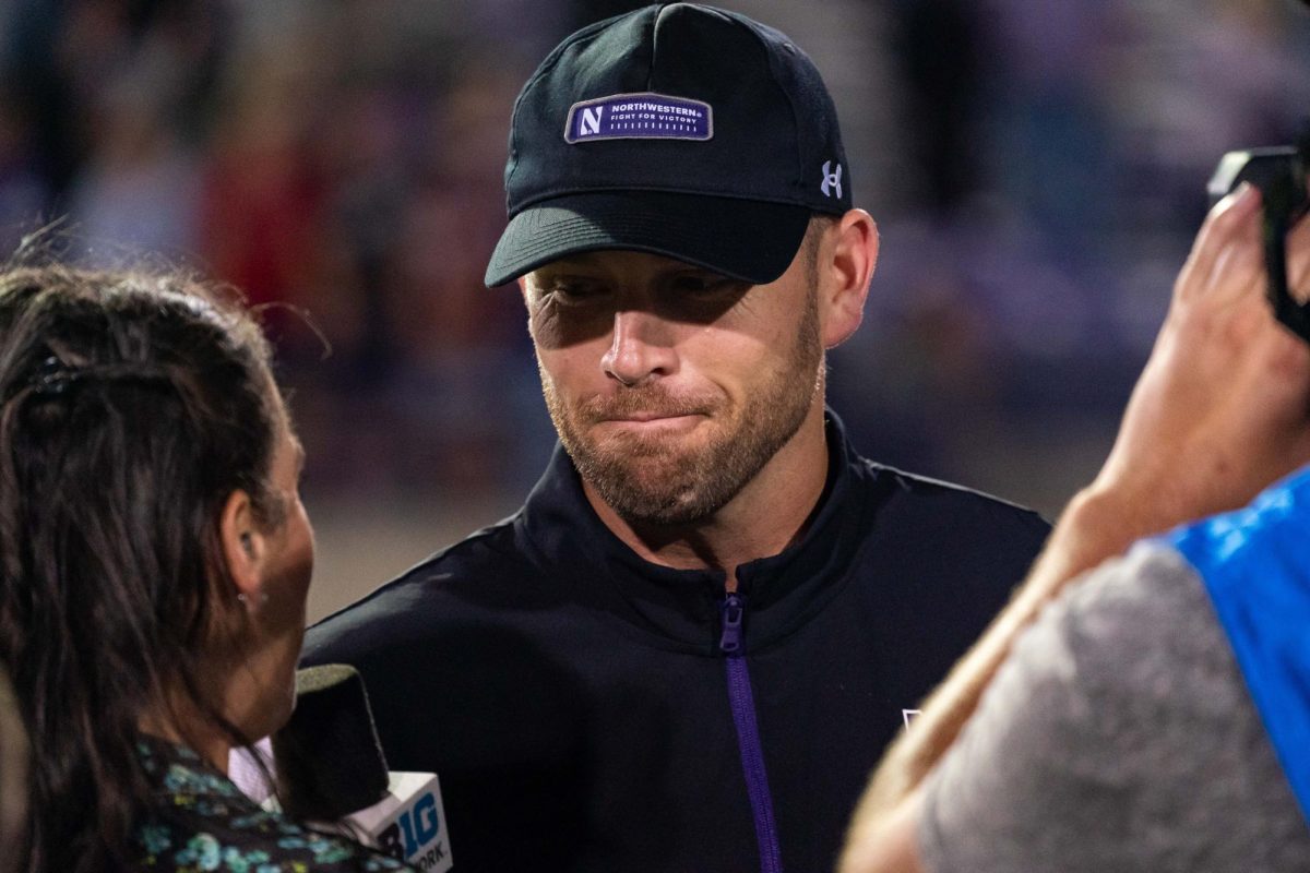 Coach David Braun turns Big Ten Network reporter during post-game interview after Northwestern’s win over Minnesota. He was named Big Ten Coach of the Year on Tuesday.