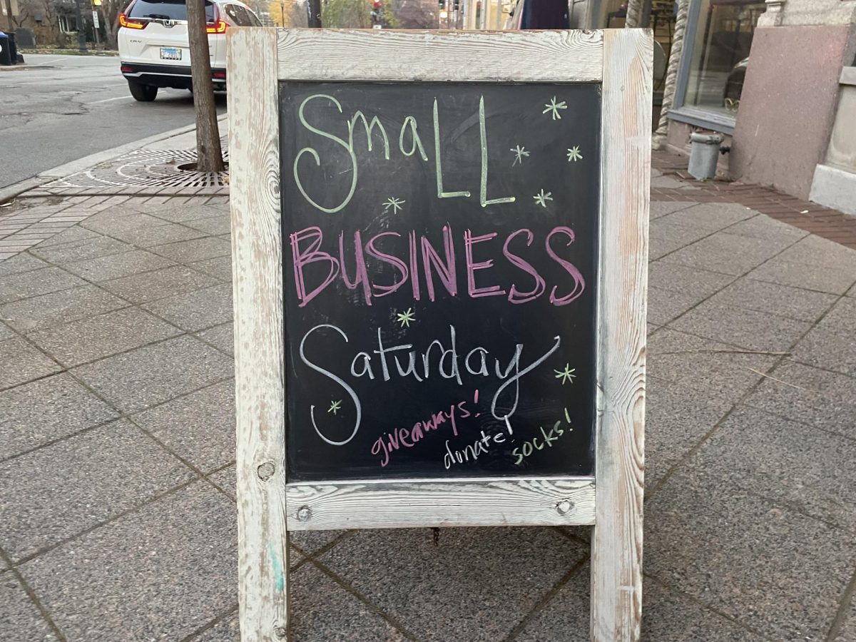 A+chalkboard+sign+that+says+Small+Business+Saturday%2C+with+the+words+%E2%80%9Cgiveaways%2C%E2%80%9D+%E2%80%9Cdonate%E2%80%9D+and+%E2%80%9Csocks%E2%80%9D+in+smaller+letters+below.