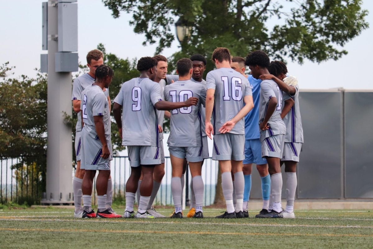 Northwesterns players huddle together. Five ‘Cats earned slots on All-Big Ten teams, while graduate student goalkeeper Jackson Weyman received a sportsmanship honor.
