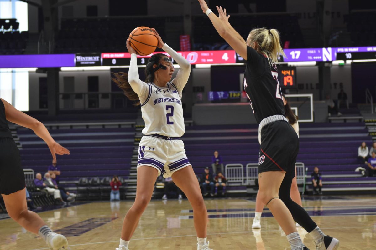 Sophomore guard Caroline Lau looks to pass the ball. Lau totaled 11 points, 12 assists and five rebounds in Northwesterns 87-69 win over Omaha on Sunday.