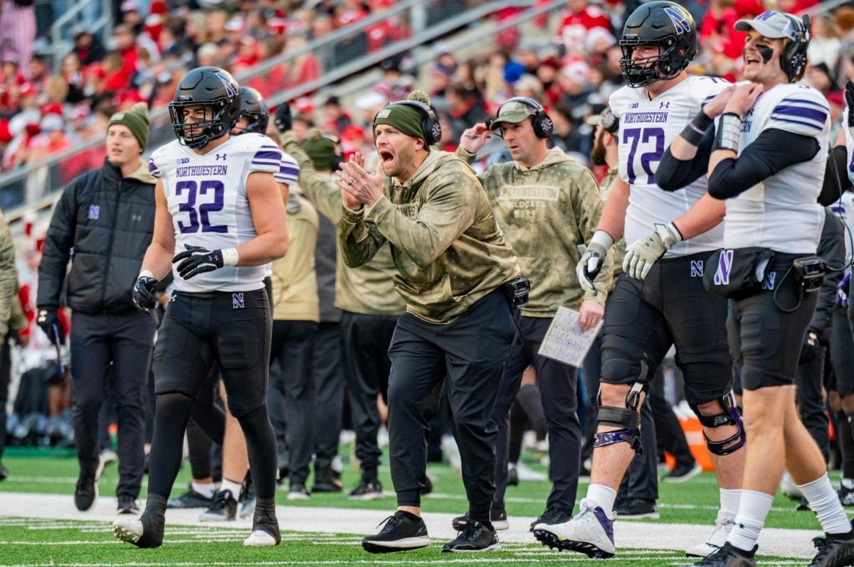 Northwestern head coach David Braun claps on the sideline against Wisconsin. It has been reported Braun made his first imprint on next season’s coaching staff after the team’s bowl victory over Utah.