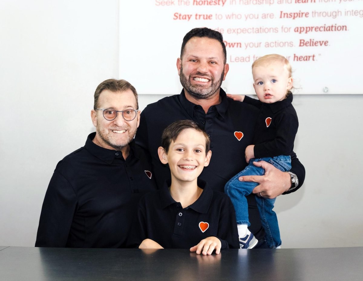 HEART+Certified+Auto+Care+owner+Brian+Moak+stands+with+his+father+and+two+sons.+