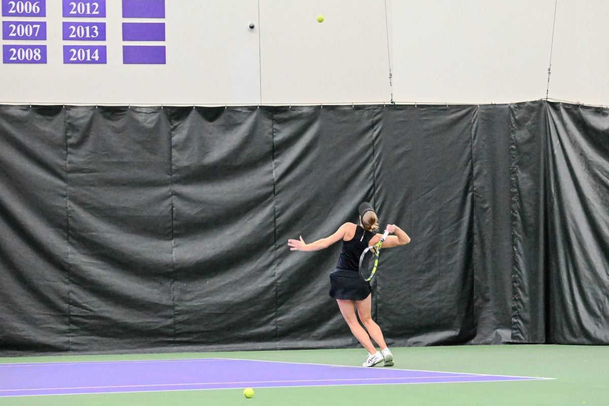 Sydney Pratt swings the racquet at a ball above her head.