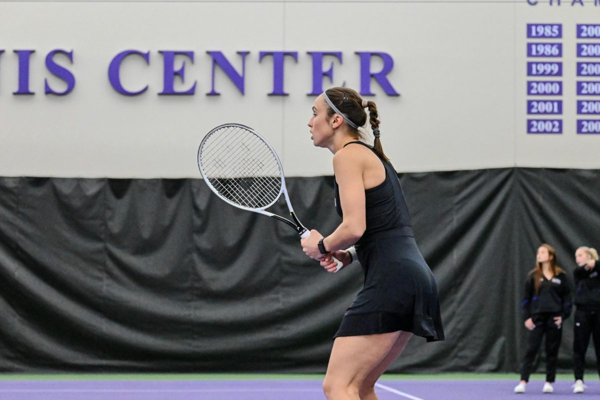 Maria Shusharina, in profile, holding her racket up.