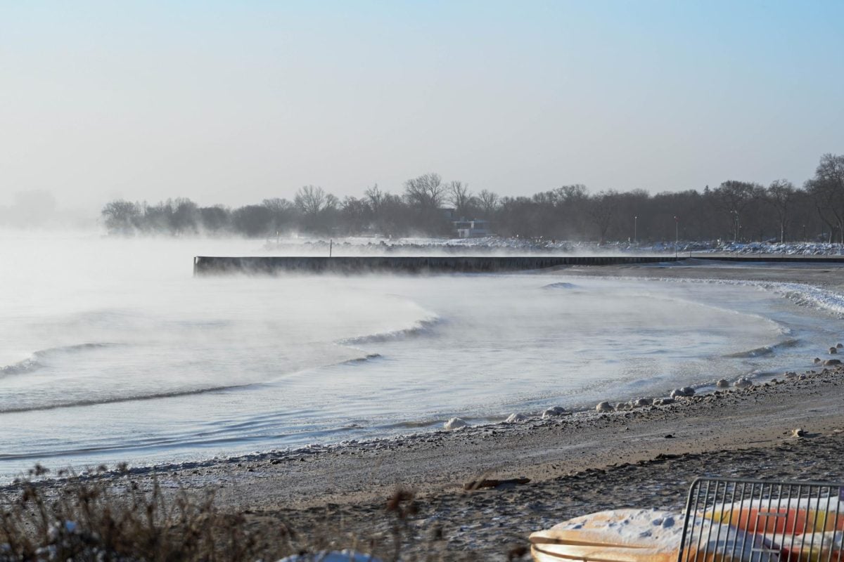 Water vapor rises over the Lake Michigan shore near Evanston’s dog beach on Sunday morning in subzero temperatures.
