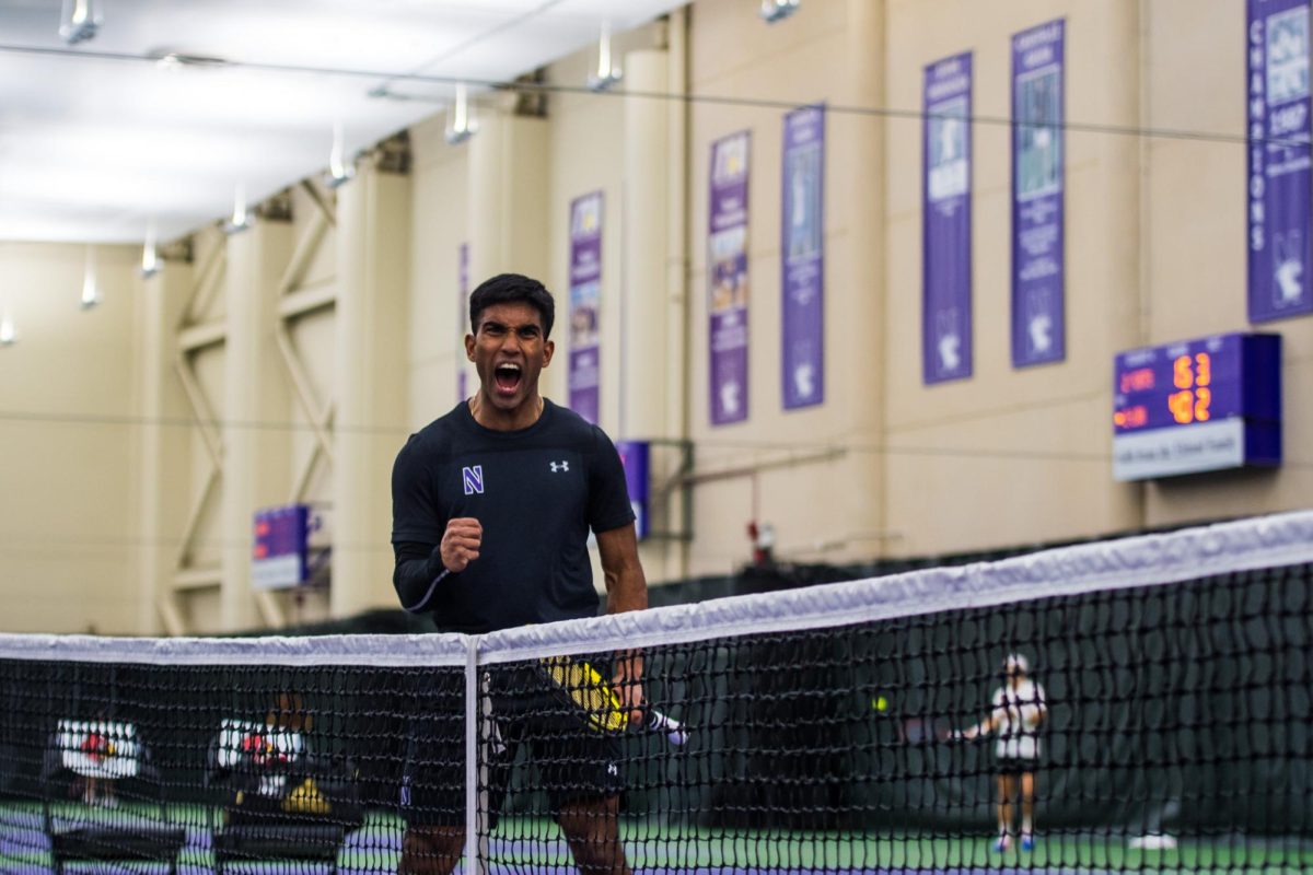 Tennis player Saiprakash Goli pumps his fist and screams in celebration.