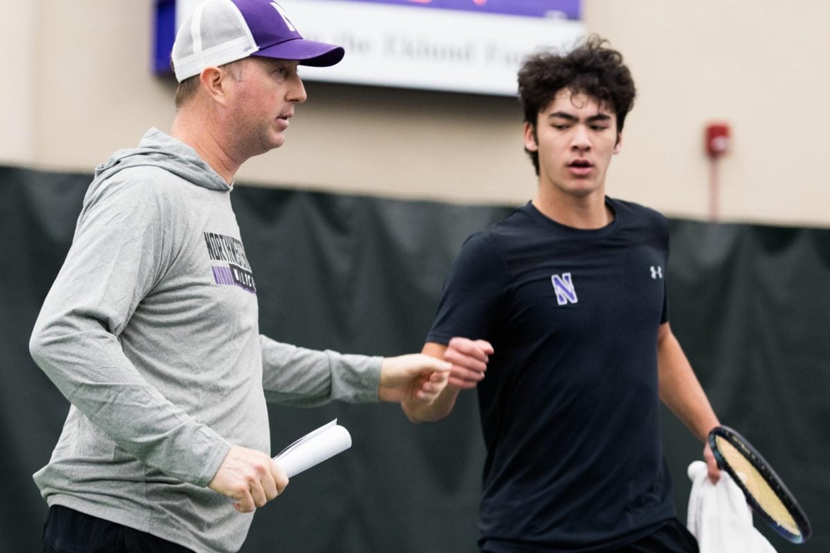 Arvid Swan, head coach of Northwestern Men’s Tennis, holds out his fist to tennis player Greyson Casey for a fist bump.