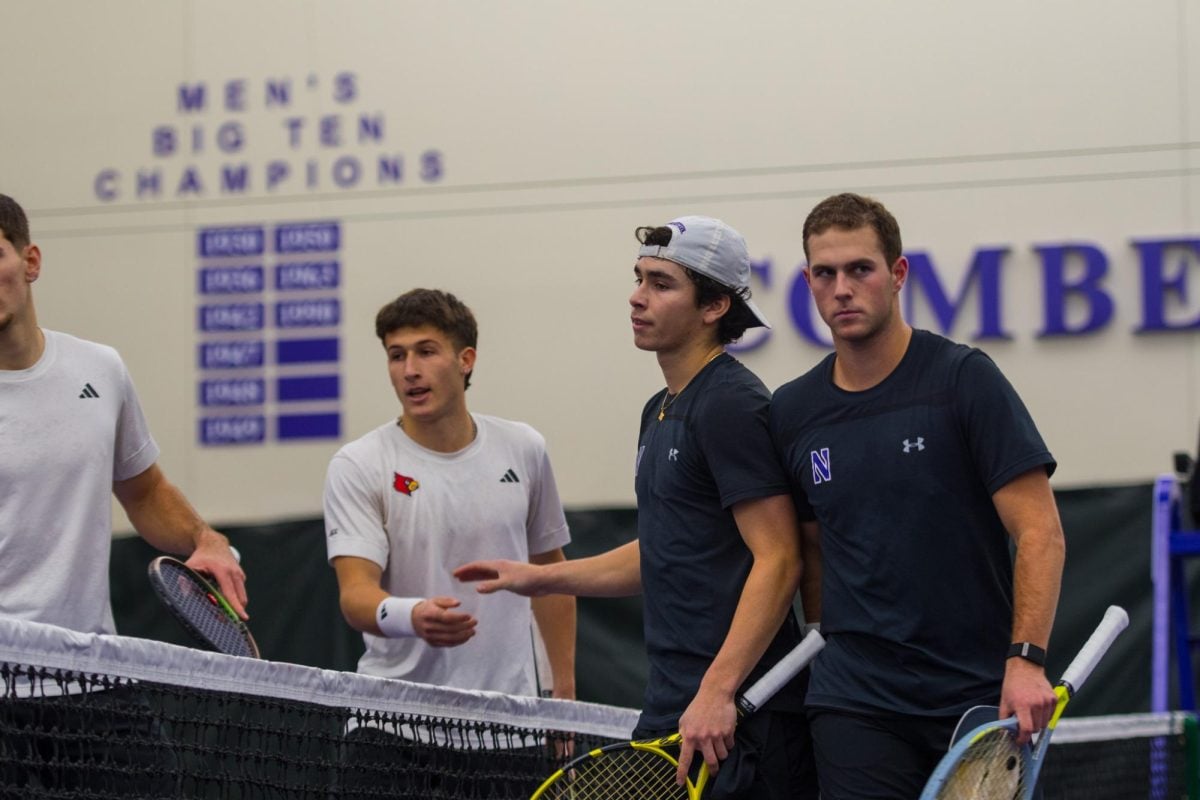 Tennis doubles partners Chad Miller and Owen Megargee shake hands with two Louisville players.
