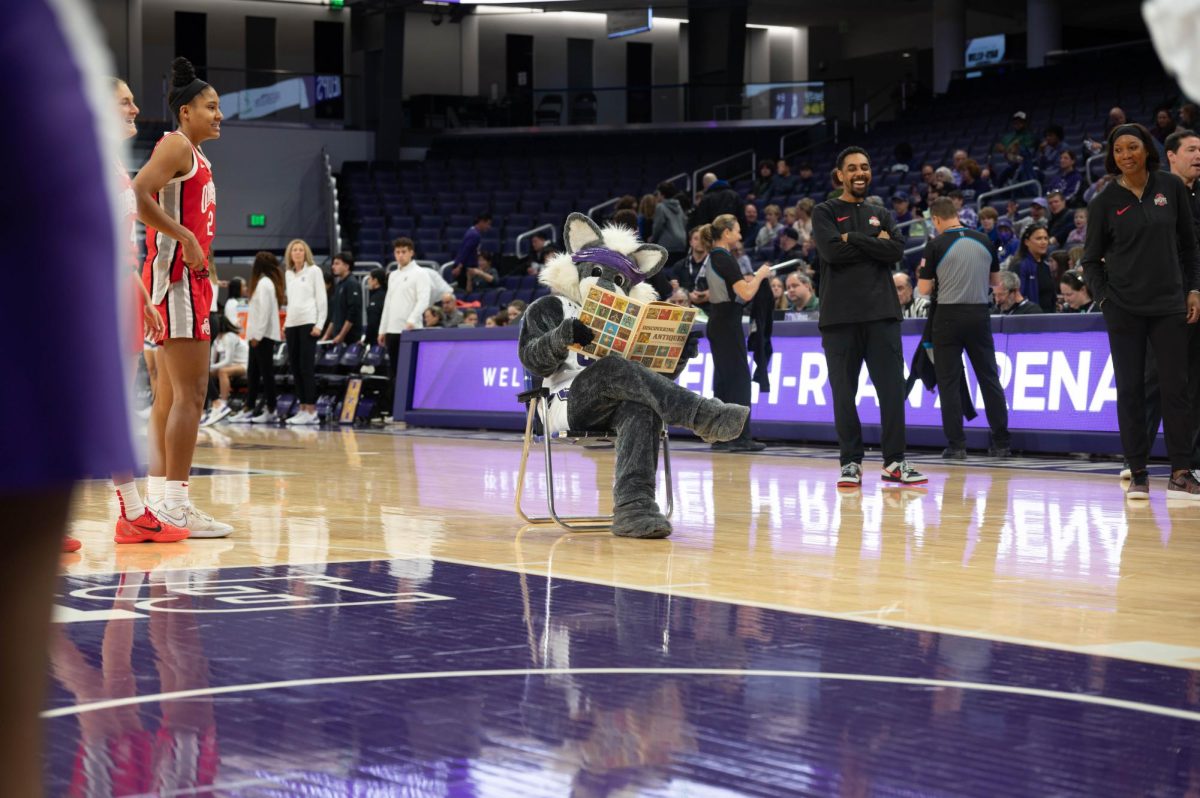 Willie the Wildcat reads a book in a beach chair during the announcement of the Ohio State starting lineup.