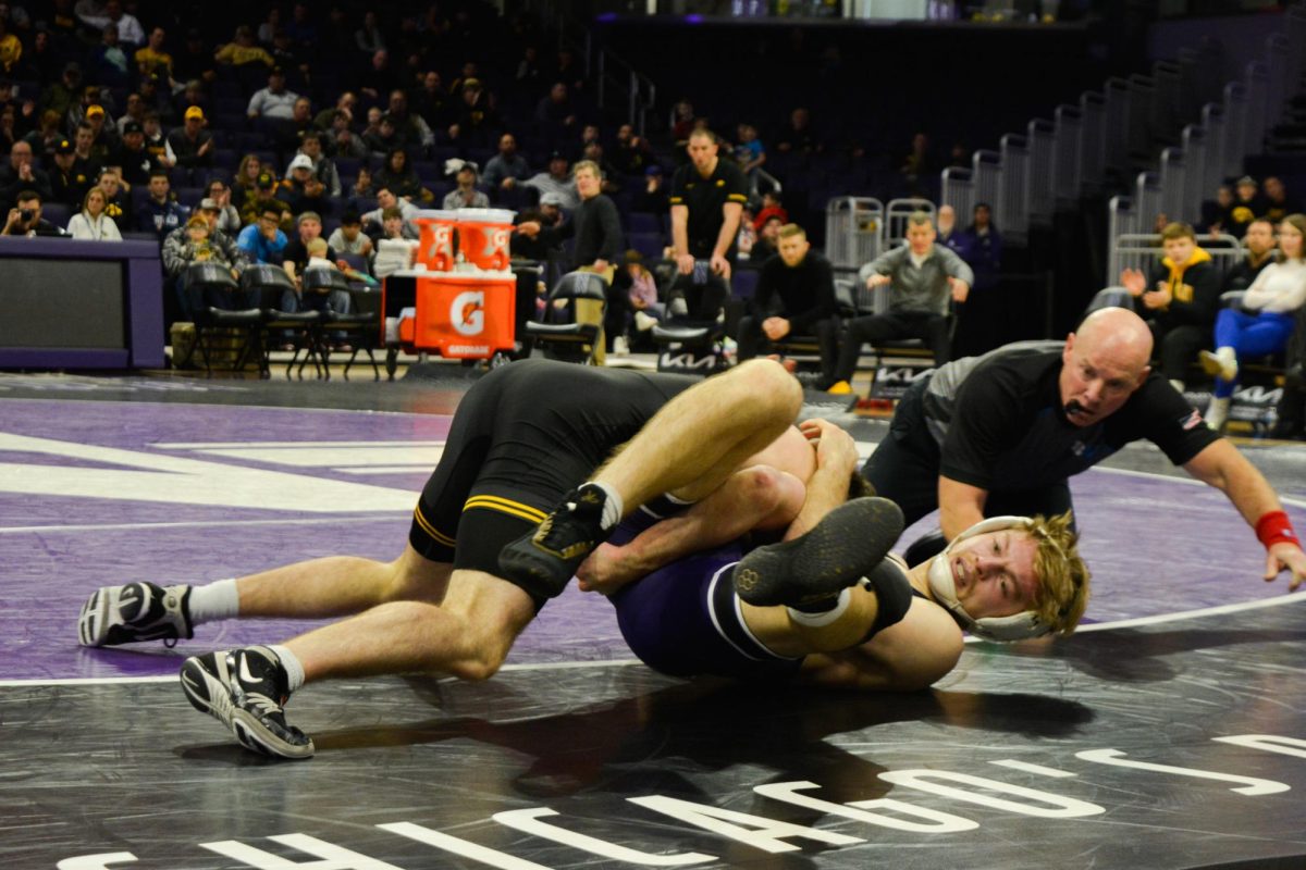 149-pounder Aiden Vandenbush falls to his back as his opponent lands a takedown and attempts a pin.
