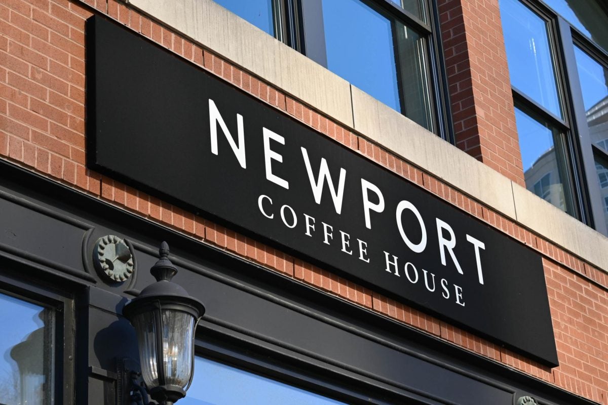 Outdoor sign of Newport Coffee House above entrance.