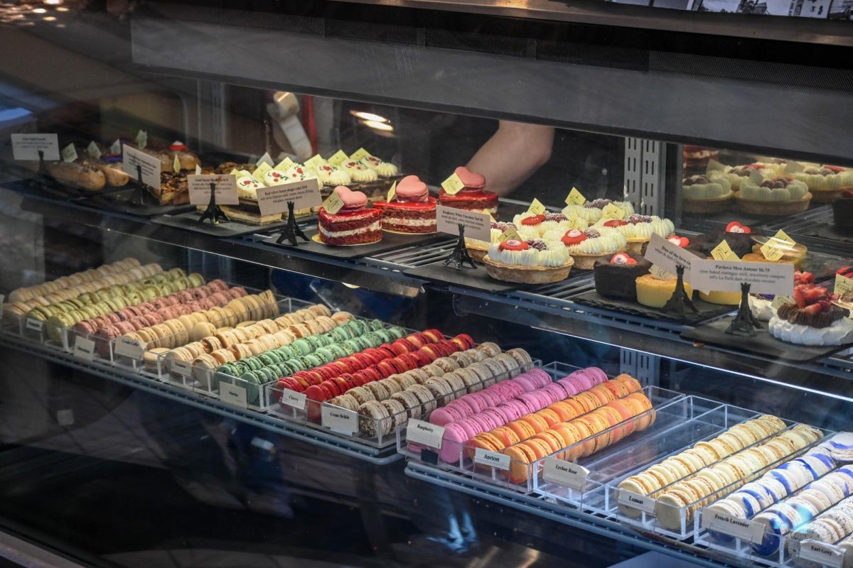 Display of macarons and cakes sold at Patisserie Coralie.