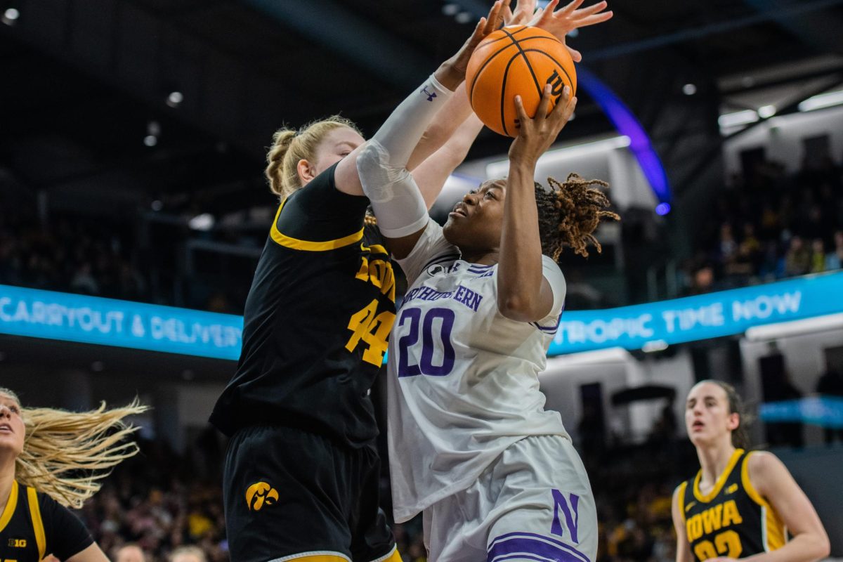 Paige Mott tries to get the ball up against an Iowa defender.