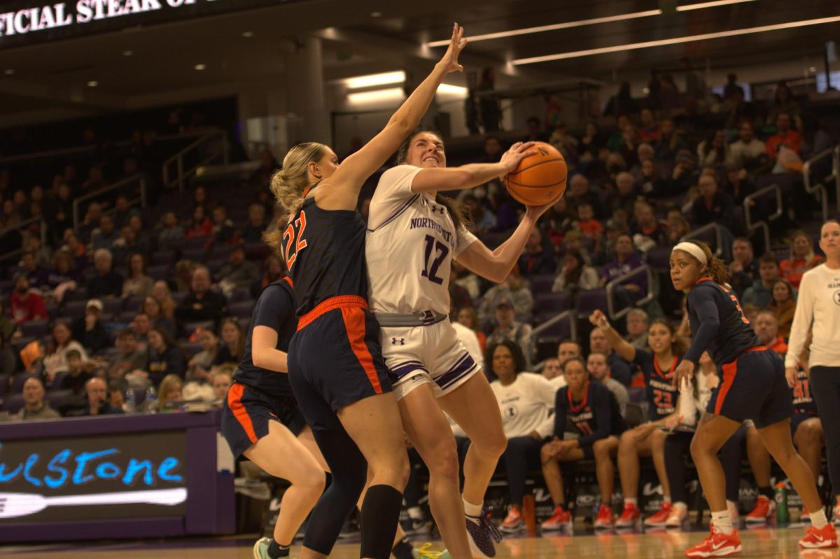  Freshman guard Casey Harter attacks the basket versus Illinois defenders in their first matchup of the season on Jan. 14 at Welsh-Ryan Arena.
