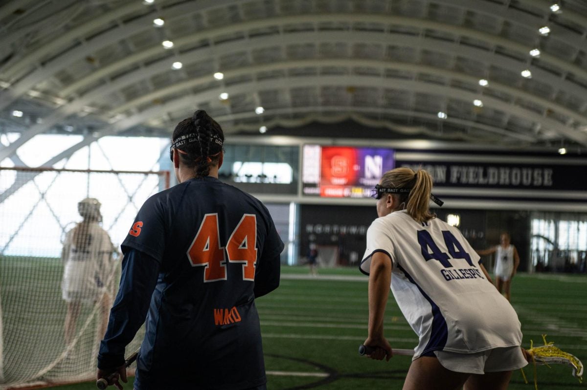 Graduate student defender Hannah Gillespie stands next to Syracuse attacker Emma Ward in between plays.