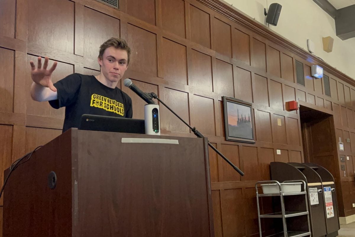 ETHS senior Milo Slevin speaks at an event before Monday’s board meeting celebrating a new sustainability policy for the school. 