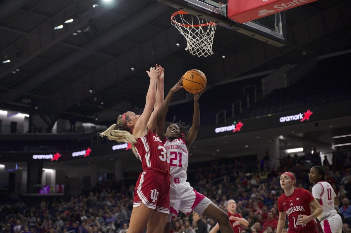Melannie Daley fights traffic to get to the rim.