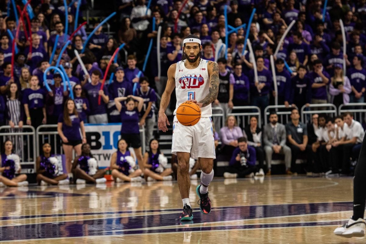 Graduate student guard Boo Buie dribbles the ball down the court. Buie logged a career-high 44 minutes in Northwestern’s overtime loss in Minnesota.