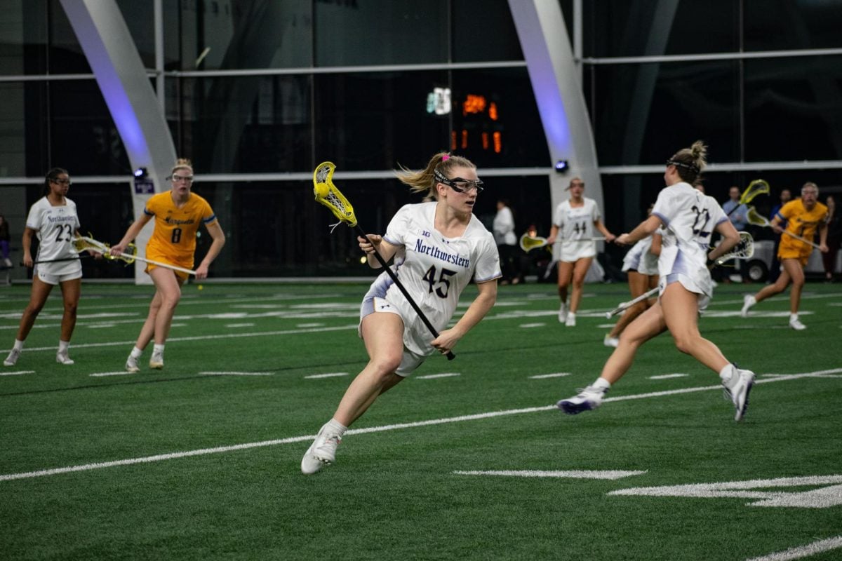 Junior midfielder Emerson Bohlig carries the ball upfield against Marquette Monday. Bohlig scored a goal and corralled five draw controls at Colorado Thursday.
