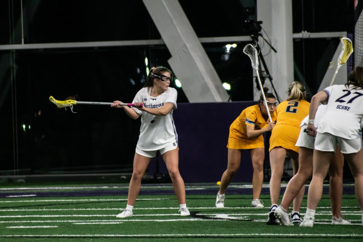 Graduate student attacker Erin Coykendall winds up for a free-position shot against Marquette on Feb. 19. Coykendall secured a first-quarter hat trick at Boston College Thursday.