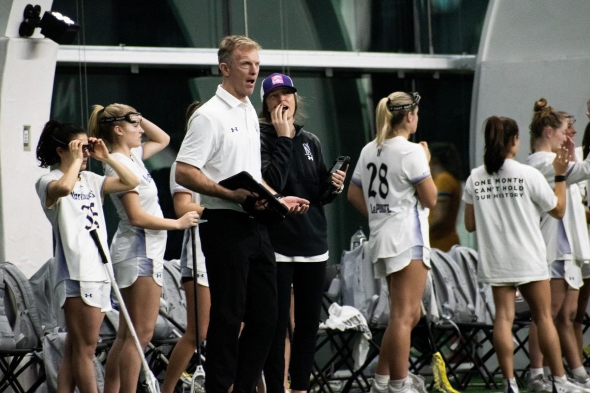 Coach Kelly Amonte Hiller and assistant coach Scott Hiller speak during then-No. 4 Northwestern’s victory against Marquette on Feb. 19. Amonte Hiller has helped usher in a major lacrosse boom in Illinois for more than two decades. 